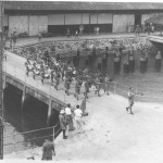 The pipes and drums of a Scottish infantry regiment marching on the quay at Kowloon to pipe us away on our sailing. This with an escort of the RAF out to sea was the customary farewell.