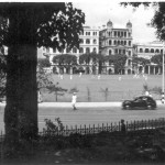 Hong Kong Cricket Club with a match in progress in central Victoria, October 1950. Queens Road runs from left to right. On the other side are the Police HQ, Government offices and further right the RN Dockyard. The photo was taken from the grounds of the Cheero Club.